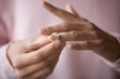© fizkes - Close up of woman removing ring filing for divorce