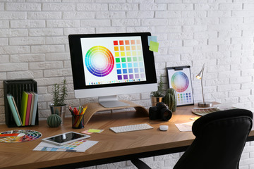 Poster - Modern computer and office supplies on wooden table. Designer's workplace