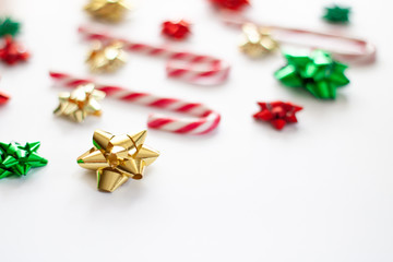 Christmas decorative background with candy cane red and white and christmas bow on the white background. Christmas Holiday Concept. Copy space