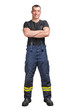 Young smiling firefighter with folded arms wearing black t-shirt and fireproof pants with suspenders. isolated on a white background