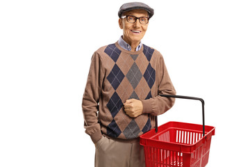 Wall Mural - Elderly man smiling and holding a shopping basket