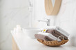 © New Africa - Basket with clean towels on counter in bathroom. Space for text