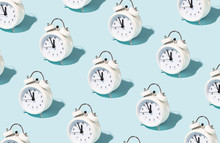 Pattern Made Of White Alarm Clocks On Blue Background. Trendy Conceptual Photo With Open Composition.