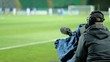 A professional cameraman shoots a football match. Broadcasting a football match