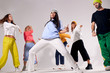 © alfa27 - Portrait of cheerful girls and guys dancing at party, having pleasure, focused on practicing breakdancing, hip hop, street dance, house dance concept, shot from below