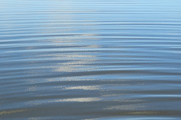 Closeup of light blue river water texture, natural water background