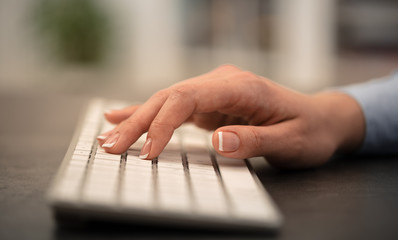 Wall Mural - Hand typing on keyboard with office concept