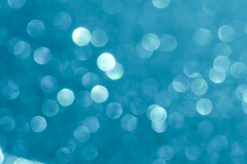 blue Sparkling Lights Festive background with texture. Abstract Christmas twinkled bright bokeh defocused and Falling stars. Winter Card or invitation	