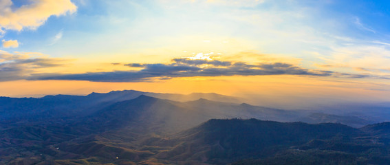 Sunset over hill or mountain at forest.