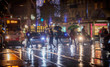 people walking with umbrellas on rainy night in the city