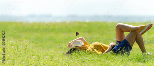 Fotomural Woman relax and sleep chill in the meadow outdoor near sea beach
