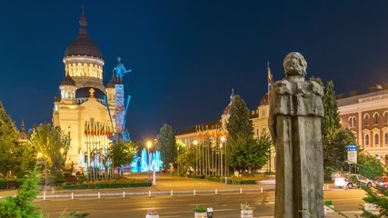 Wall Mural - Cluj-Napoca, Romania: Avram Iancu Square timelapse at night. Timelapse of the Assumption Cathedral in Cluj-Napoca, Romania. Cluj Napoca timelapse at night. Cluj nightlife, time lapse