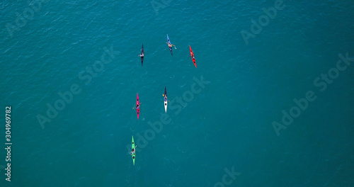Fotografía Aerial image of kayakers paddling forwards