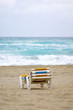 © makstar - Stacked empty sunbeds on a sand beach by the stormy ocean
