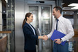 © zinkevych - Businesswoman shaking hand of her business partner while meeting near elevator