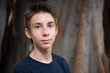 © Khorzhevska - Handsome young boy at summer park. Beautiful calm smiling teen boy against nature background. Teenage lifestyle.