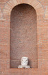 An empty niche with a column base builded by red bricks in Rome Italy