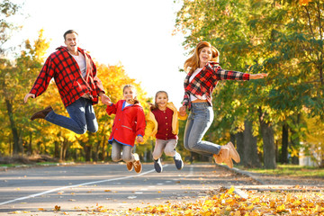 Canvas Print - Happy family having fun in autumn park