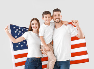 Wall Mural - Family with USA flag on light background. Memorial Day celebration