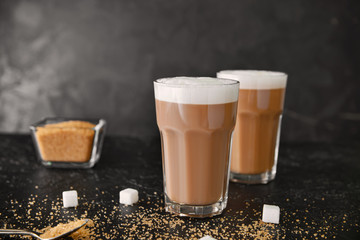 Glasses of tasty latte on table