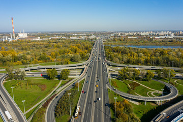 Aerial shot of  big freeway intersection in Warsaw, traffic going fast through many road flyovers. Aerial view of a motorway with several traffic intersections in Warsaw, 