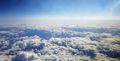 landscape above the clouds seen from the plane