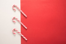 Christmas Candy Canes On White And Red Background