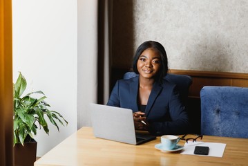 happy young african american businesswoman using computer in office