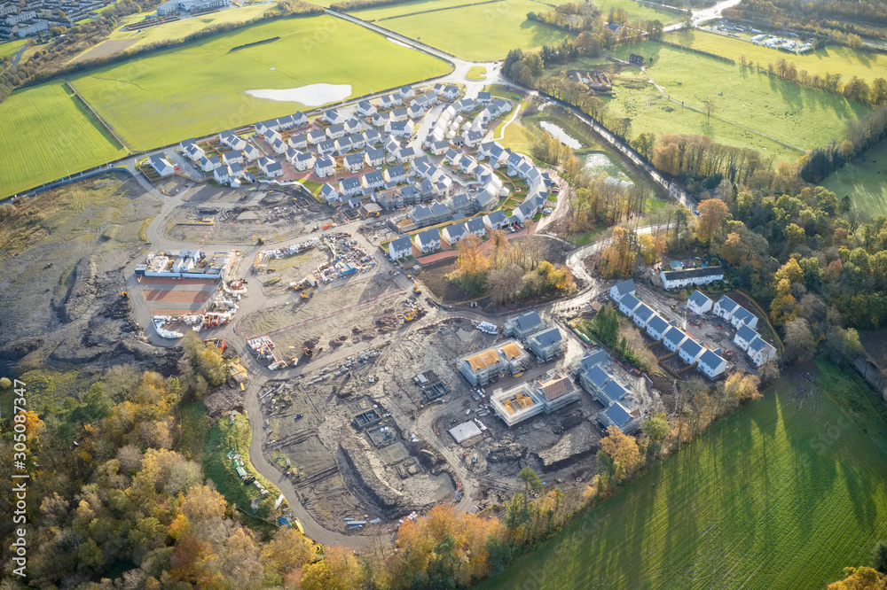 Large housing development aerial view in construction on rural countryside site Scotland UK - obrazy, fototapety, plakaty 