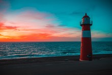 Lighthouse On The Beach With The Colorful Sky, Zeeland, Netherlands