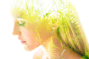 Double exposure close up profile portrait of a young pretty woman interwoven with bright leaves of a vibrant tropical tree