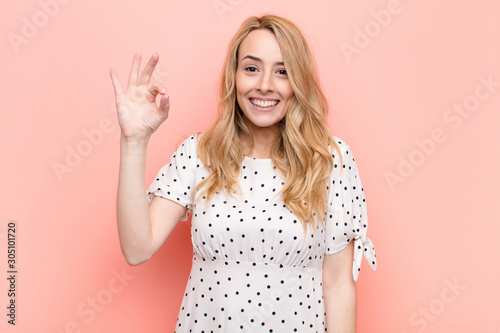 young pretty blonde woman feeling happy, relaxed and satisfied, showing approval Tableau sur Toile