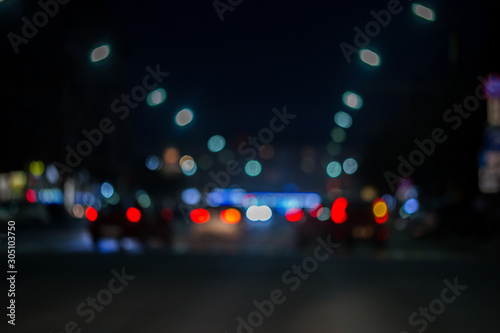 Fotomural defocused view from the car window with blurry lighting of city traffic on the c