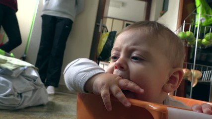 Wall Mural - Funny upset baby inside laundry bucket. Angry tearful toddler boy wanting attention