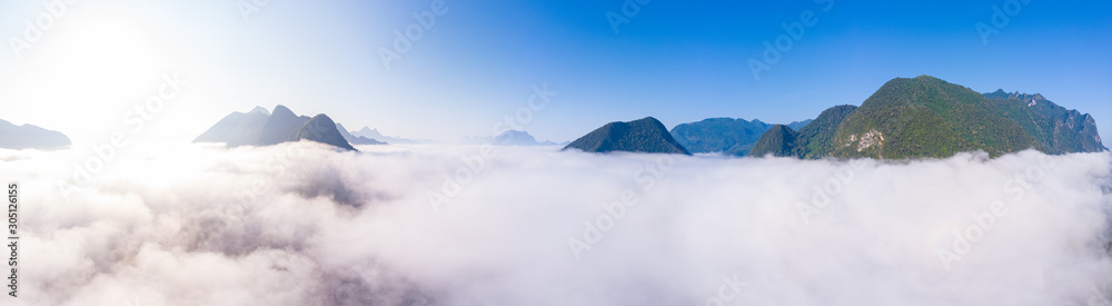 Aerial panoramic Nam Ou River drone flying over morning fog mist and clouds, Nong Khiaw Muang Ngoi Laos, dramatic landscape scenic pinnacle cliff, famous travel destination in South East Asia - obrazy, fototapety, plakaty 