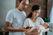 © Odua Images - asian mother using thermometer feel worried about their children's health in the house