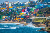Fototapeta  - Colorful houses line the hill side overlooking the beach in San Juan, Puerto Rico.