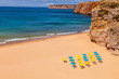 Deserted beach with colorful parasols in the Algarve Portugal