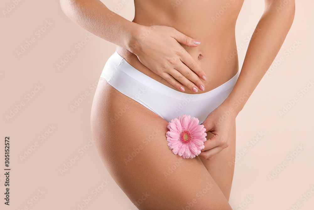 Young woman with flower on light background. Gynecology concept - obrazy, fototapety, plakaty 