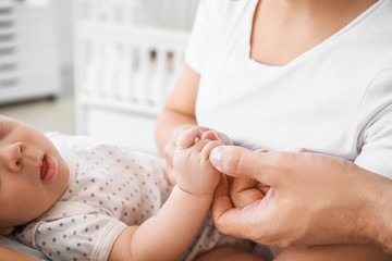 Wall Mural - Young parents with newborn baby in maternity hospital, closeup