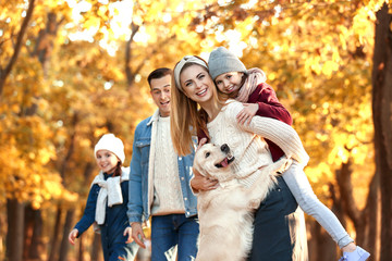 Canvas Print - Happy family with dog in autumn park