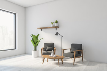 White living room corner with gray armchairs