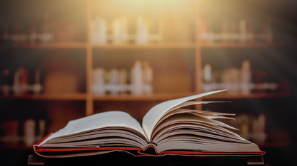 Poster - Stack of books in the library and blur bookshelf background