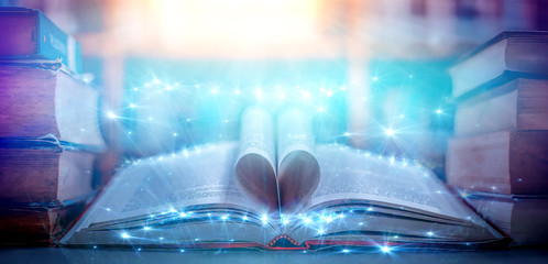 Poster - The blurred book that is bewitched with magic, the magic light in the dark, with the bright light shining down as the power to search for knowledge. For research and use as a blurred background