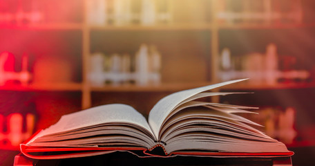 Poster - Stack of books in the library and blur bookshelf background