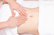 © Elena - Massage Therapist Massaging a Womens Stomach. Massage and body care. Spa body massage woman hands treatment.