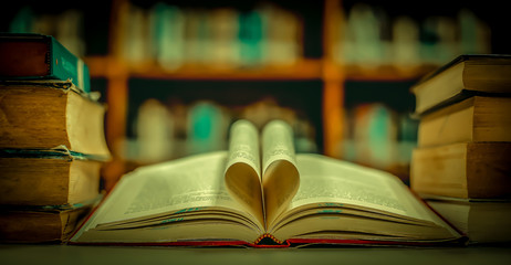 Poster - Stack of books in the library and blur bookshelf background
