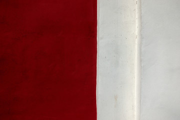 Two colors wall background. Red and light gray plaster wall backdrop