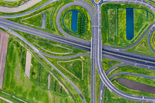 A Cloverleaf Highway With Traffic In The Middle Of Green Fields Near Waalwijk, Brabant, Netherlands