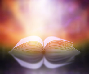 Poster - Imagine a picture book of an ancient book opened on a wooden table with a sparkling golden background. With magical power, magic, lightning around a glowing glowing book In the room of darkness